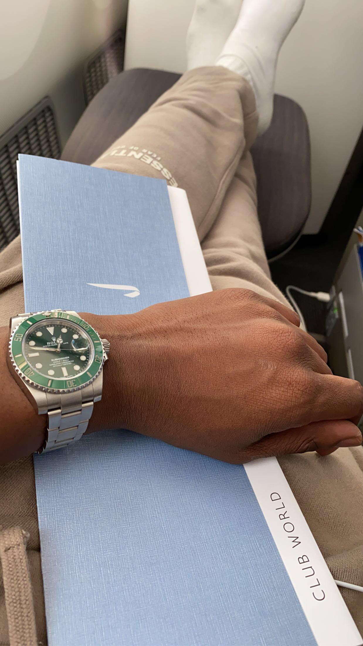  A Rolex Submariner with a distinctive green dial and matching bezel on a stainless steel bracelet.